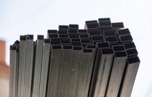 Stacked hollow steel sections on a construction site