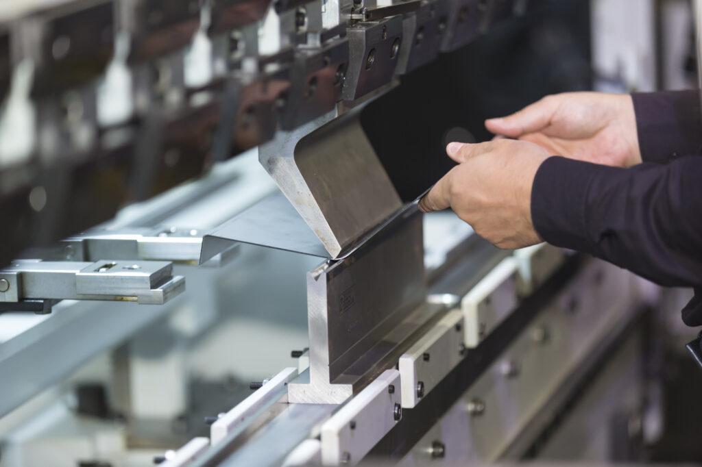 operator bending metal sheet by sheet bending machine