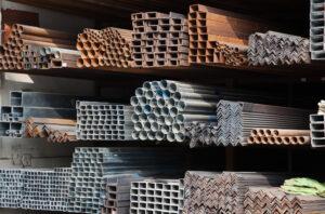 A series of different sizes metal pipes on shelf