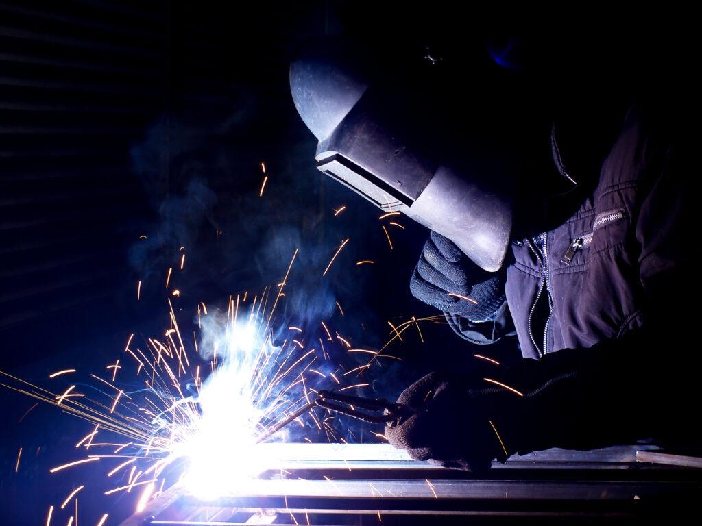 close up of worker fabricating steel
