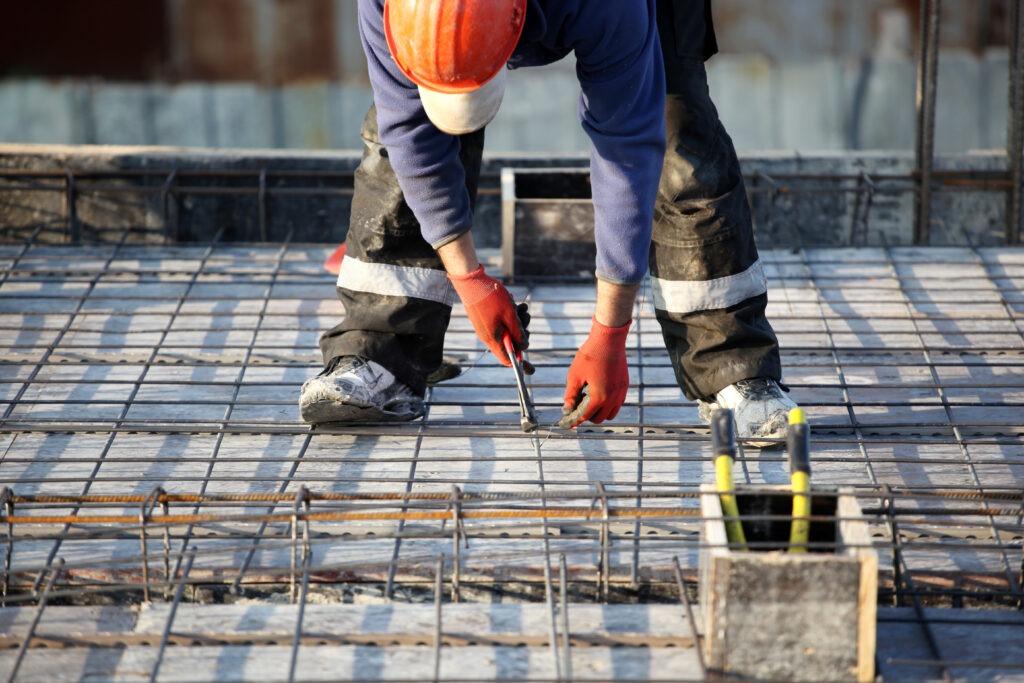 construction site worker assembling structural steel