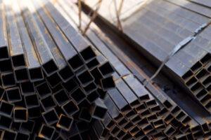 A pile of steel pipes in a factory.