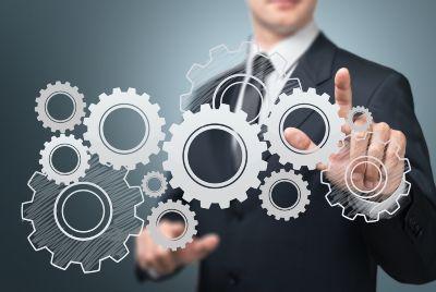 man pointing at some illustrated cogs