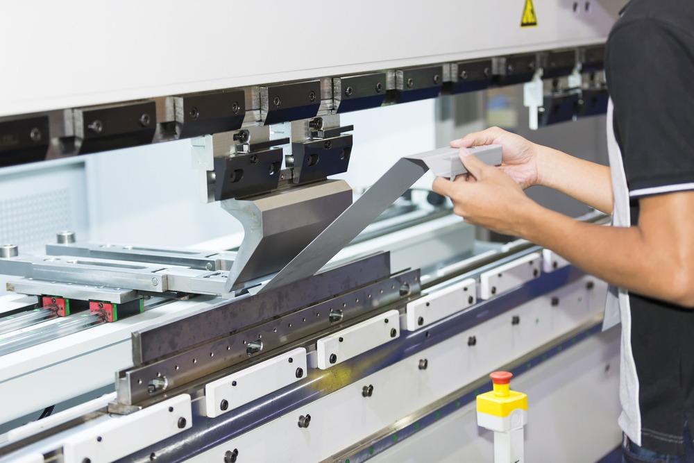 A man is working on a machine in a factory.