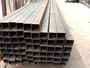 A pile of steel pipes stacked on top of each other.