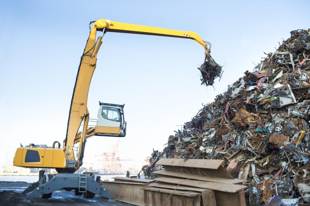 digger recycling steel at a recycling plant