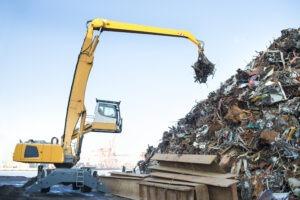 digger recycling steel at a recycling plant