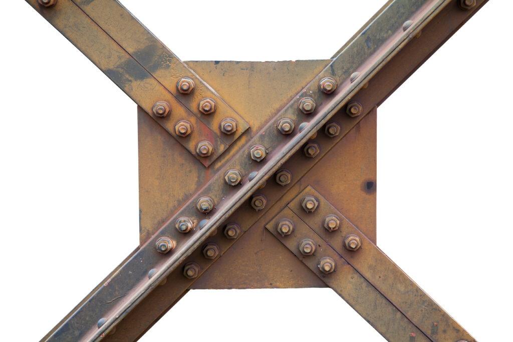 Rusty metal beams crossed and bolted together, isolated against a white background.