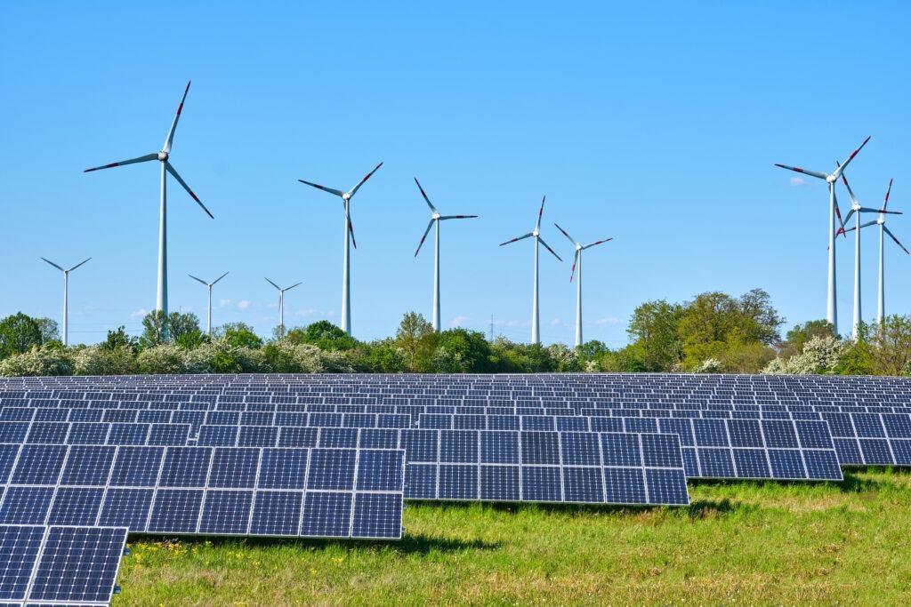 Solar panels and wind turbines at a renewable energy site