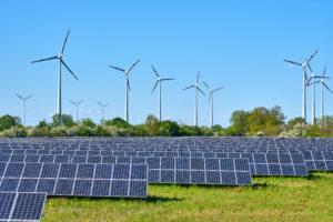 Solar panels and wind turbines at a renewable energy site