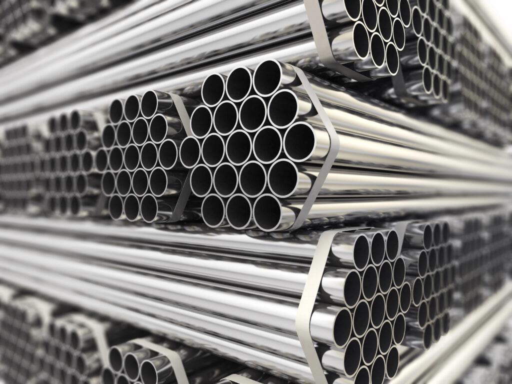 A stack of shiny metal pipes arranged in bundles.