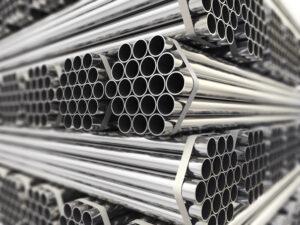A stack of shiny metal pipes arranged in bundles.