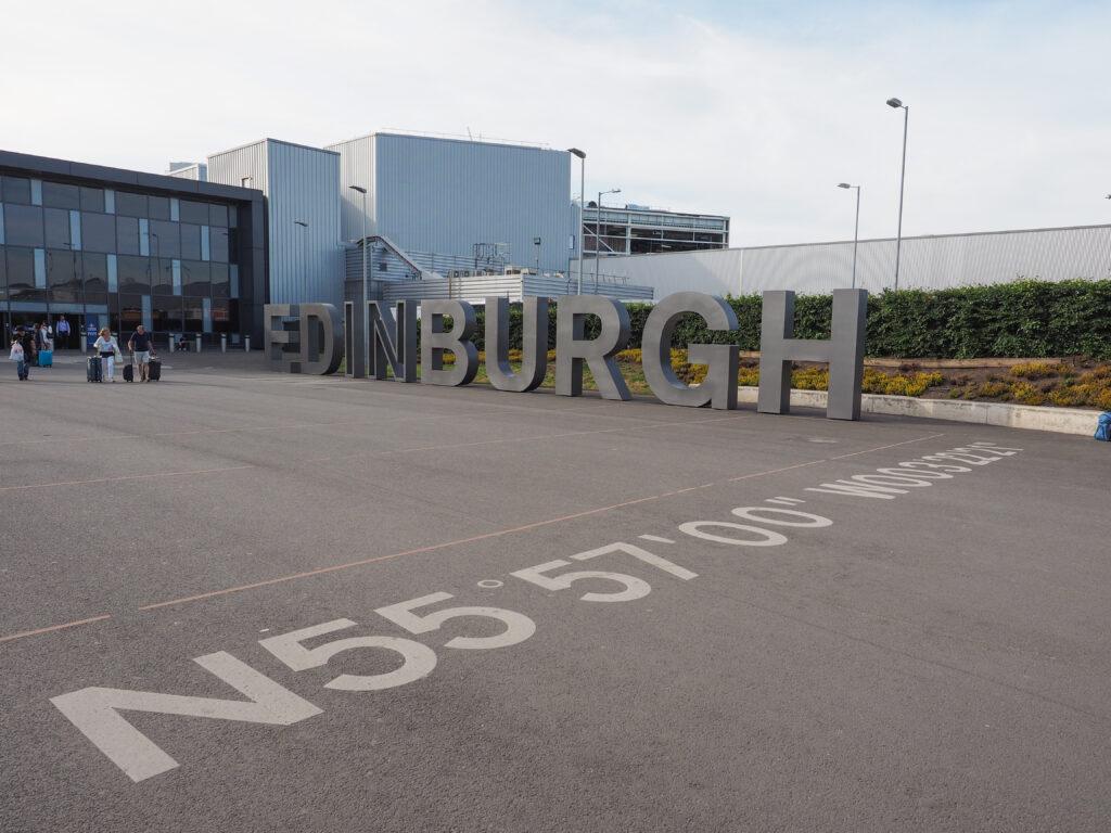 Edinburgh structural steel: steel letters spelling EDINBURGH outside Edinburgh Airport, coordinates marked on the tarmac