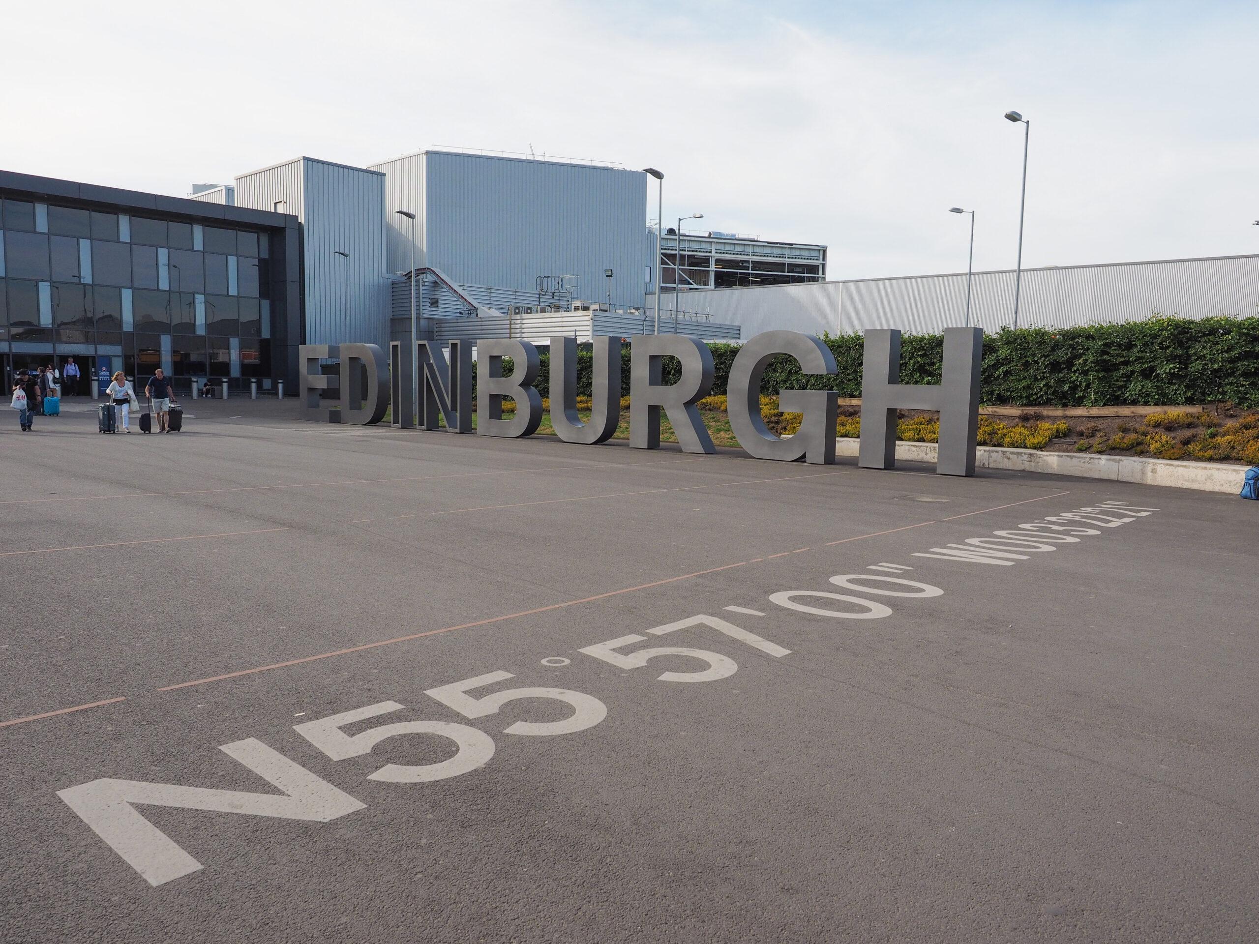 Edinburgh structural steel: steel letters spelling EDINBURGH outside Edinburgh Airport, coordinates marked on the tarmac
