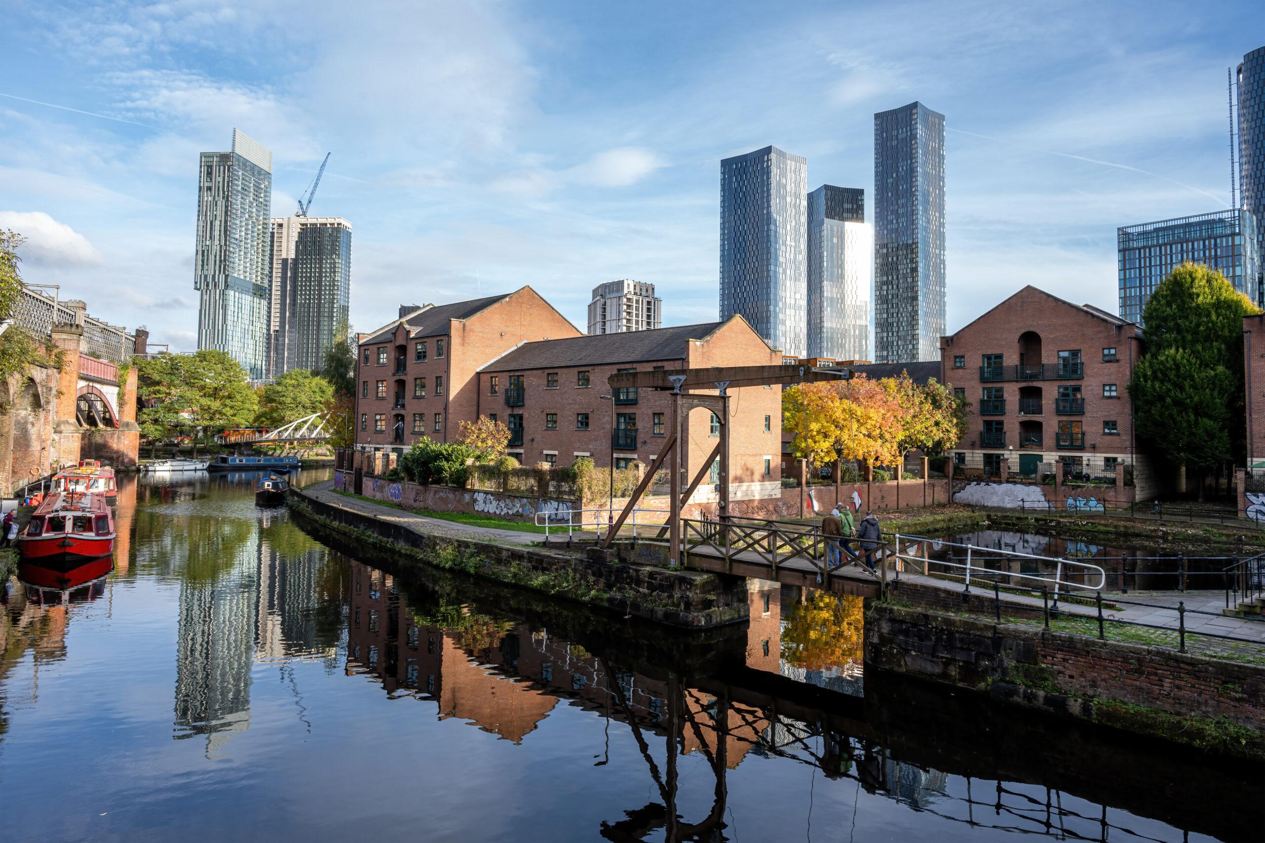 Steel and iron in Manchester's skyline: Castlefield's iron railway viaduct and canal warehouses below the Beetham Tower and Deansgate Square towers